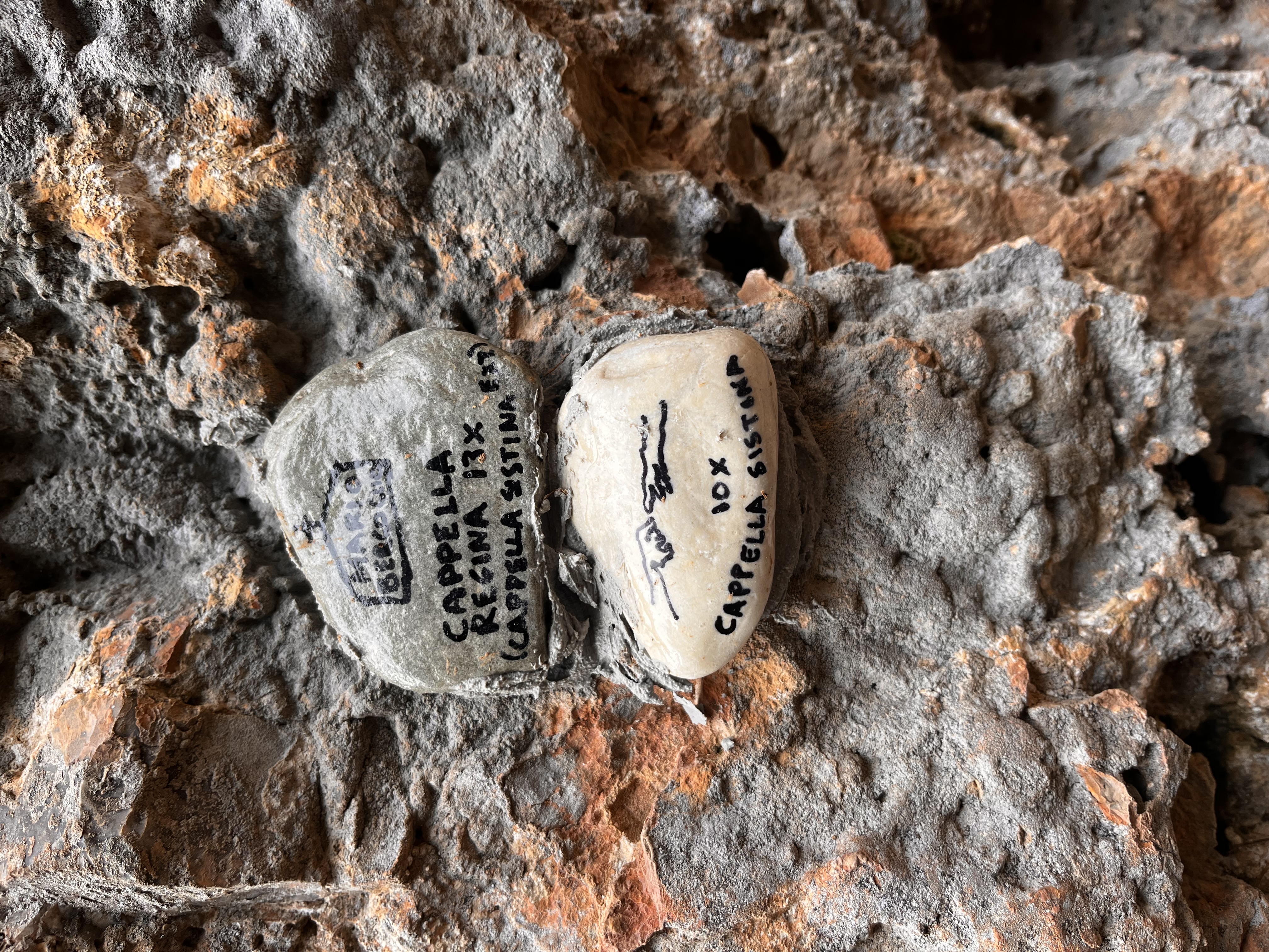 Custom route stones designating each climbing route at sector Capella